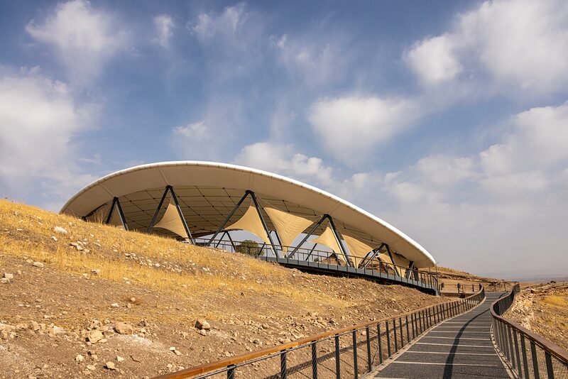 The membrane canopy over the main excavation area, seen from the approach path